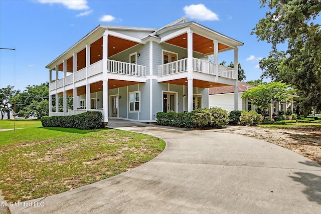 631 2nd St, Gulfport, MS 39501 - view of front facade featuring a balcony and curved driveway