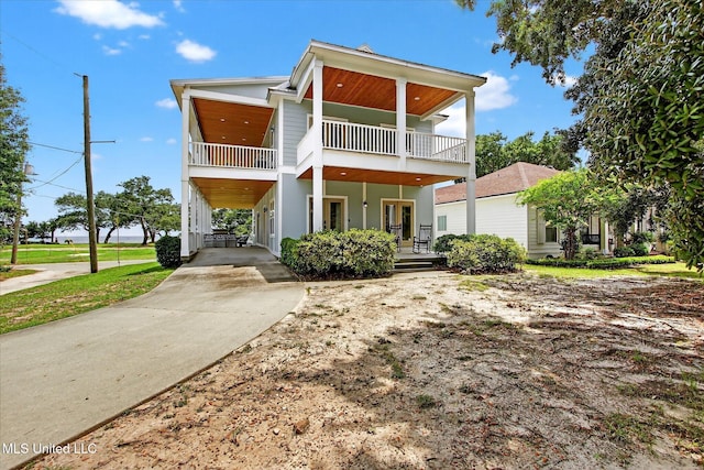 631 2nd St, Gulfport, MS 39501 - view of front of home with a balcony, concrete driveway, a porch, and a carport
