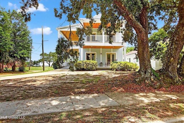 631 2nd St, Gulfport, MS 39501 - view of front of property featuring french doors, a balcony, covered porch, and stucco siding