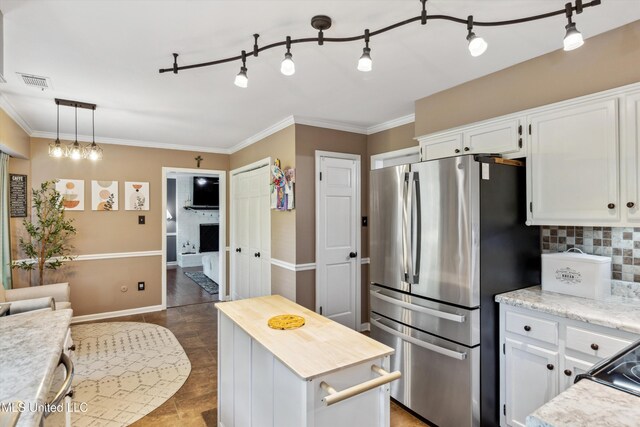 7465 Davidson Rd, Olive Branch, MS 38654 - kitchen with freestanding refrigerator, white cabinetry, decorative backsplash, wooden counters, and ornamental molding