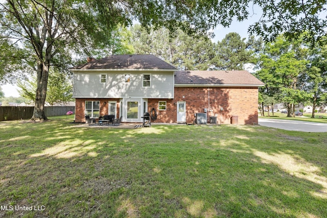 7465 Davidson Rd, Olive Branch, MS 38654 - rear view of property featuring brick siding, a patio, and central AC