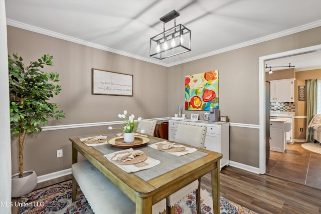 7465 Davidson Rd, Olive Branch, MS 38654 - dining area featuring ornamental molding, dark wood-type flooring, and baseboards