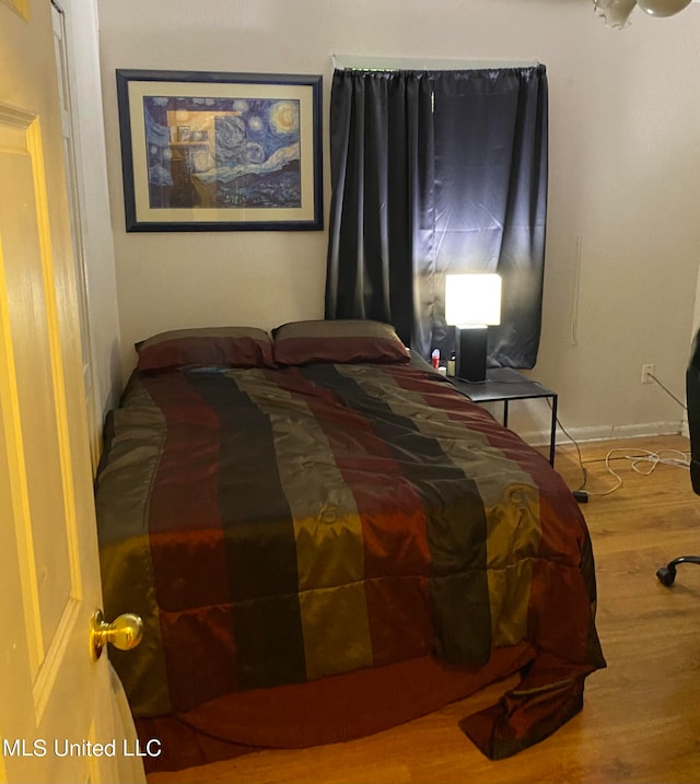 bedroom with wood-type flooring