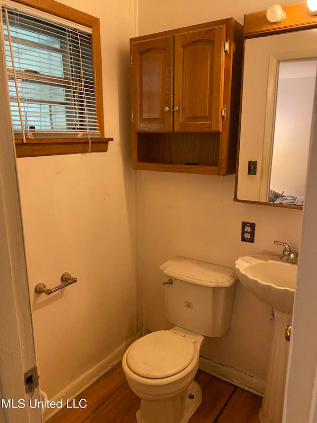 bathroom with toilet and hardwood / wood-style flooring