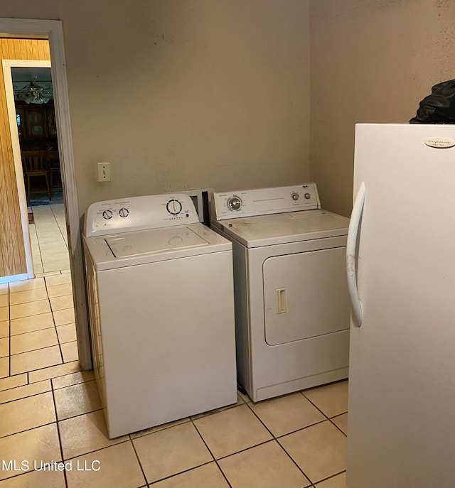 laundry area with light tile patterned flooring and washing machine and clothes dryer