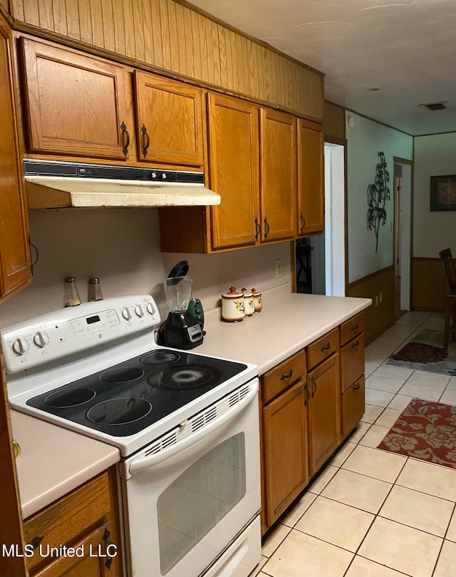 kitchen featuring electric stove and light tile patterned floors