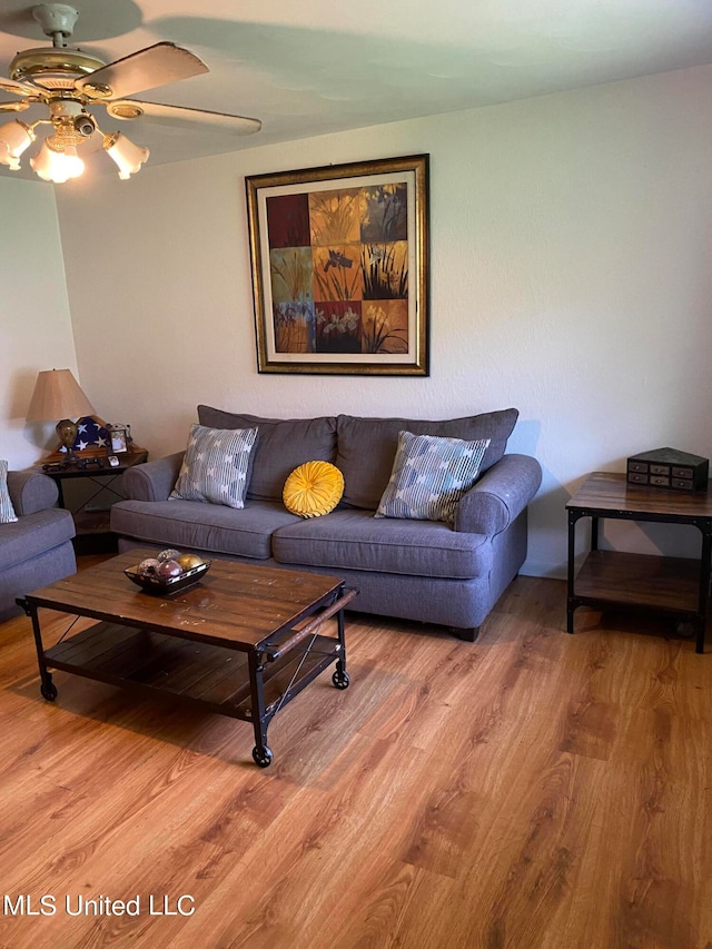 living room featuring ceiling fan and wood-type flooring