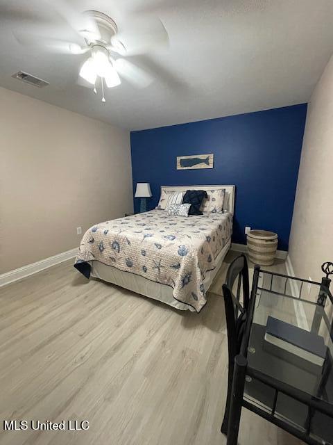 bedroom featuring light hardwood / wood-style flooring and ceiling fan