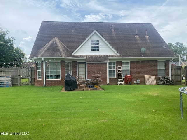 rear view of house with a yard