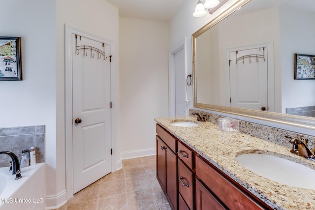 2018 Pelican Cir, Long Beach, MS 39560 - bathroom featuring double vanity, a garden tub, baseboards, and tile patterned flooring