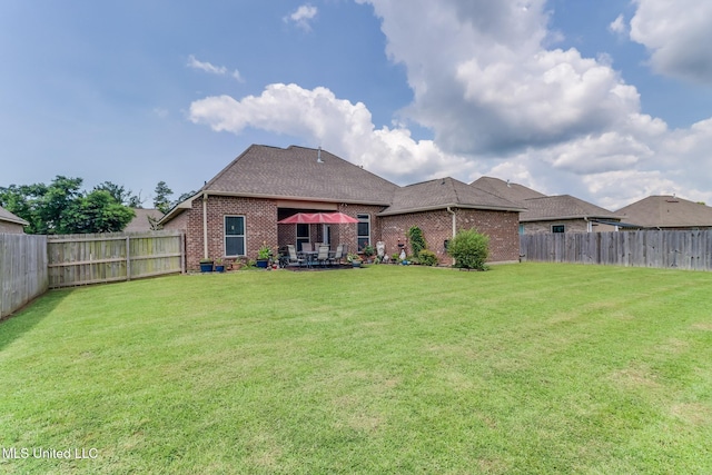 2018 Pelican Cir, Long Beach, MS 39560 - back of property with brick siding, a patio area, and a shingled roof