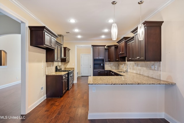 kitchen featuring sink, crown molding, light stone counters, decorative light fixtures, and stainless steel range with gas cooktop