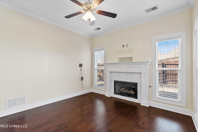 unfurnished living room featuring hardwood / wood-style flooring, crown molding, ceiling fan, and a fireplace