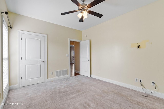 unfurnished bedroom with light carpet and ceiling fan