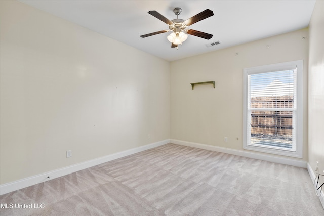 spare room featuring ceiling fan and light colored carpet