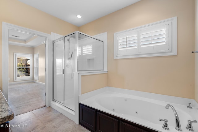 bathroom with tile patterned flooring and separate shower and tub