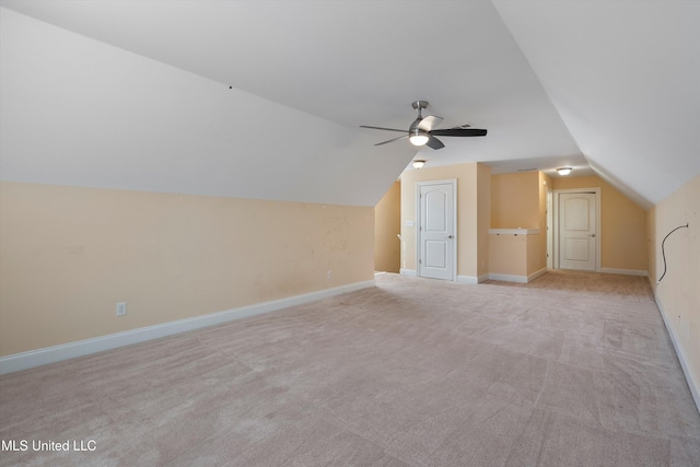 additional living space featuring lofted ceiling, light colored carpet, and ceiling fan