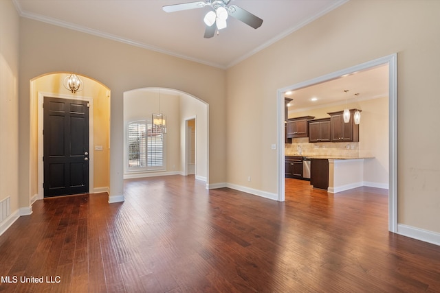 unfurnished living room with crown molding, sink, dark hardwood / wood-style flooring, and ceiling fan with notable chandelier