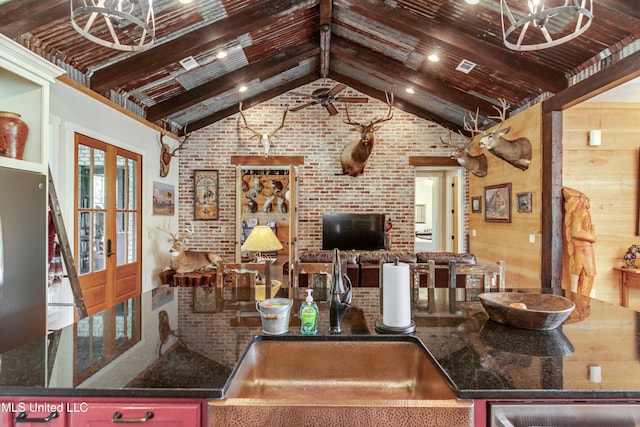 kitchen with french doors, brick wall, wooden walls, sink, and wooden ceiling