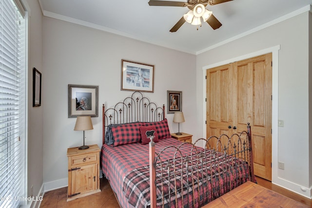 bedroom with ceiling fan, a closet, hardwood / wood-style flooring, and ornamental molding