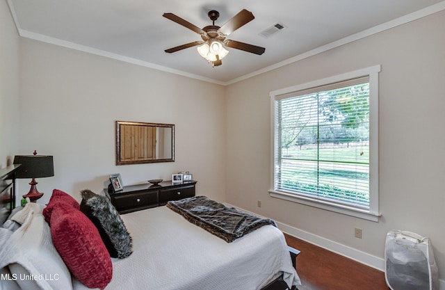 bedroom with ceiling fan and ornamental molding