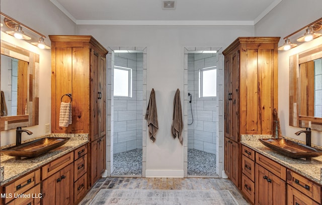 bathroom featuring tiled shower, plenty of natural light, and ornamental molding