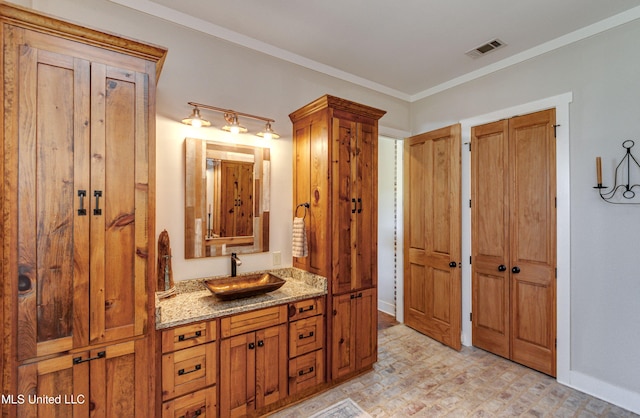 bathroom with vanity and crown molding