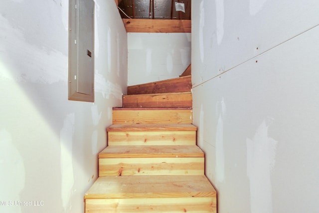 staircase featuring electric panel