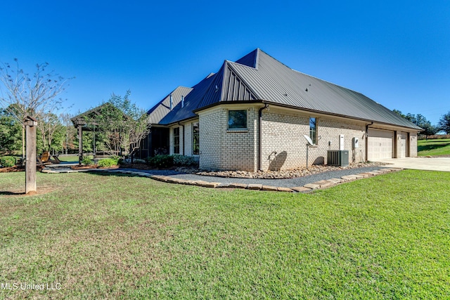 view of home's exterior featuring a lawn, cooling unit, and a garage