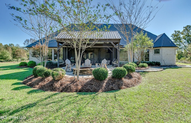 back of house featuring a patio and a lawn