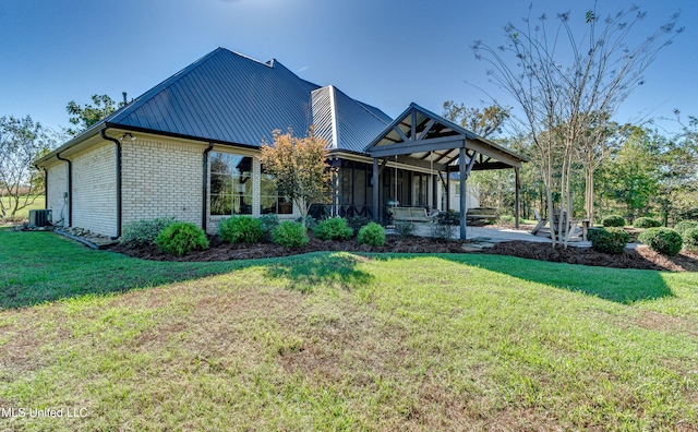 view of front of property with a sunroom, a patio area, and a front yard