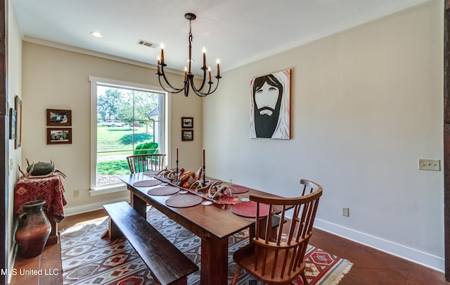 dining space featuring a notable chandelier and dark tile patterned floors
