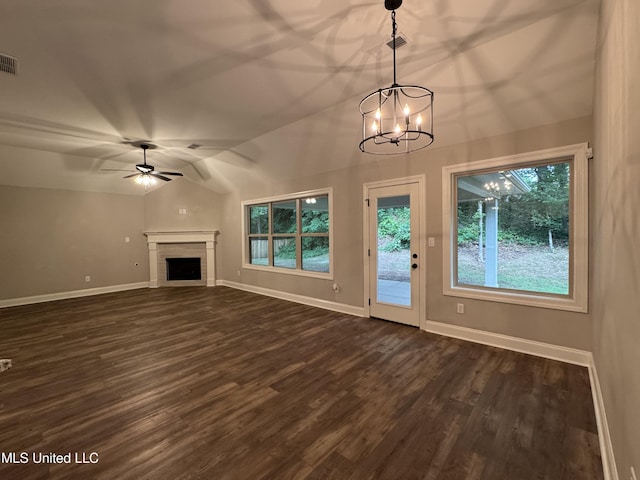 unfurnished living room featuring baseboards, plenty of natural light, vaulted ceiling, and dark wood finished floors
