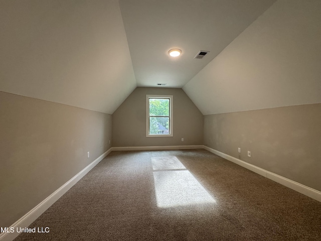 bonus room with baseboards, vaulted ceiling, carpet flooring, and visible vents
