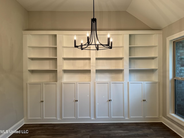 interior space with baseboards, dark wood-style flooring, lofted ceiling, and a notable chandelier