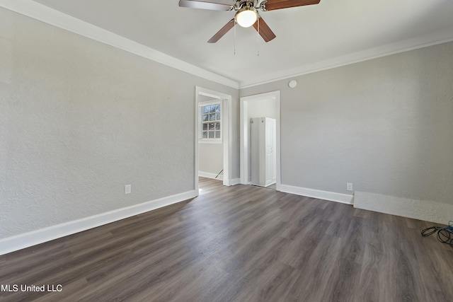 unfurnished room featuring dark wood-style floors, crown molding, a textured wall, ceiling fan, and baseboards