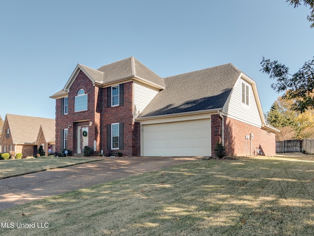 view of front of property with a garage and a front lawn