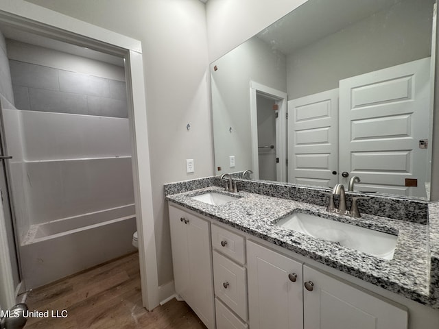 158 Walter Jones Rd, Mendenhall, MS 39114 - full bathroom with wood finished floors, double vanity, and bathtub / shower combination