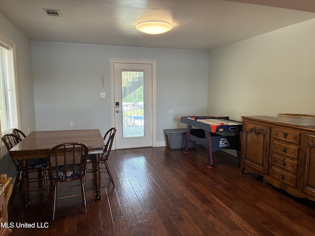6327 Pontiac Dr, Kiln, MS 39556 - dining room with dark wood-style flooring, visible vents, and baseboards