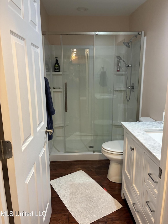 6327 Pontiac Dr, Kiln, MS 39556 - full bathroom featuring wood finished floors, toilet, a stall shower, and vanity
