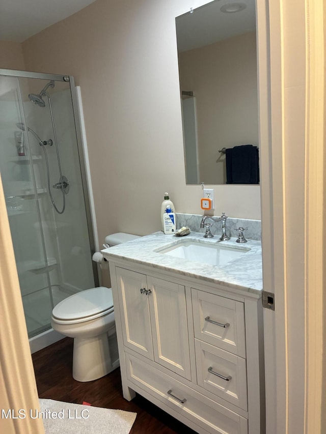 6327 Pontiac Dr, Kiln, MS 39556 - bathroom featuring toilet, a stall shower, wood finished floors, and vanity