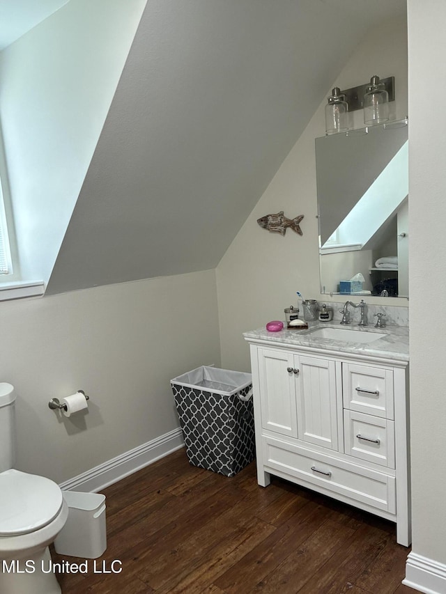 6327 Pontiac Dr, Kiln, MS 39556 - bathroom featuring toilet, vanity, vaulted ceiling, and wood finished floors