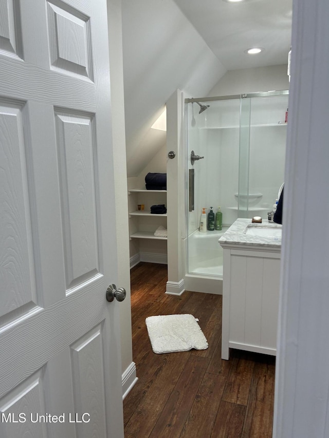 6327 Pontiac Dr, Kiln, MS 39556 - full bath with a stall shower, hardwood / wood-style flooring, vanity, and vaulted ceiling