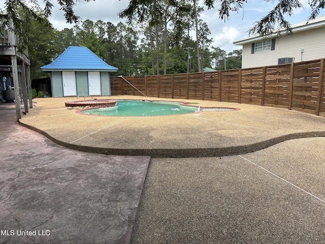6327 Pontiac Dr, Kiln, MS 39556 - view of pool featuring a patio, a fenced backyard, a hot tub, and an outdoor structure