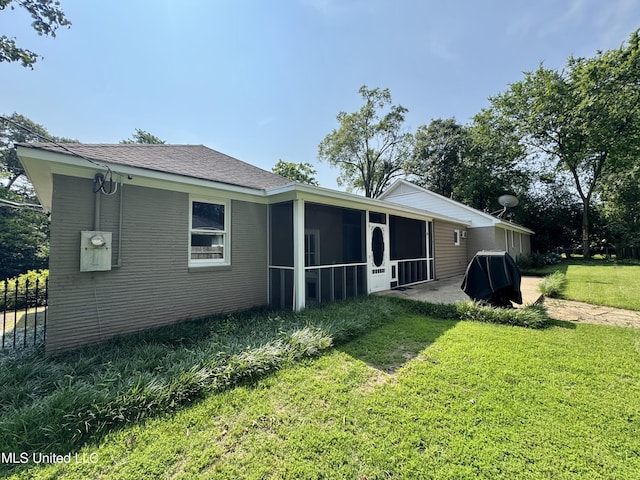 2293 Elm St, Hernando, MS 38632 - rear view of property with a sunroom and a lawn