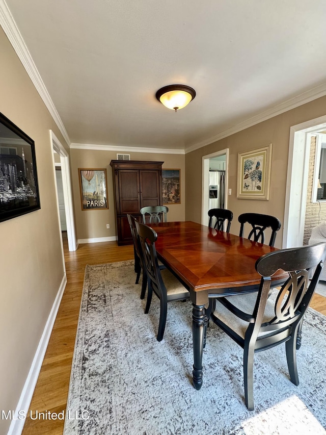 2293 Elm St, Hernando, MS 38632 - dining space with ornamental molding, light wood-style flooring, and baseboards