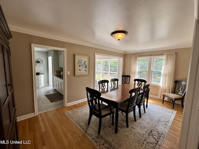 2293 Elm St, Hernando, MS 38632 - dining room featuring ornamental molding, light wood finished floors, and baseboards