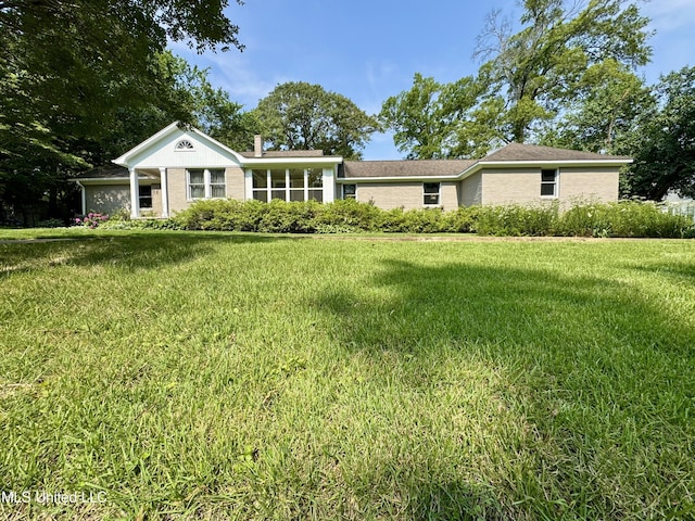 2293 Elm St, Hernando, MS 38632 - rear view of house with a lawn and a chimney