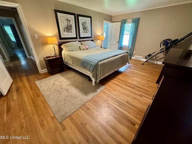 2293 Elm St, Hernando, MS 38632 - bedroom with crown molding, wood finished floors, multiple windows, and baseboards
