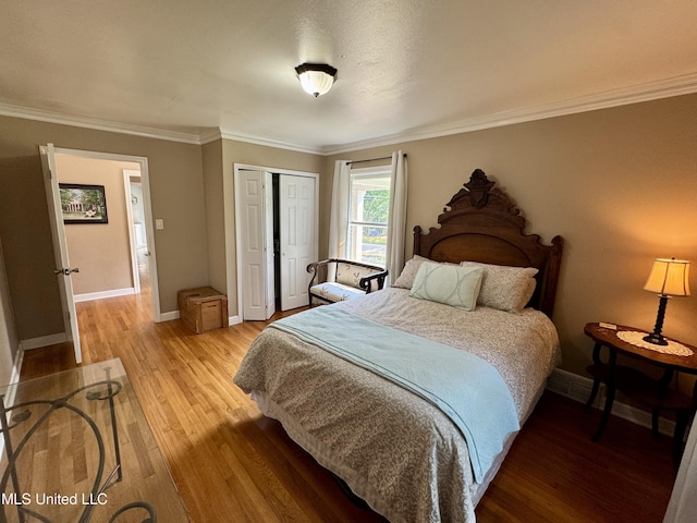 2293 Elm St, Hernando, MS 38632 - bedroom with light wood-style floors, baseboards, a closet, and ornamental molding